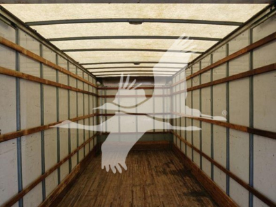 Box truck cargo area showing empty interior with wooden floor and side rails, faded light through roof, watermark overlay.