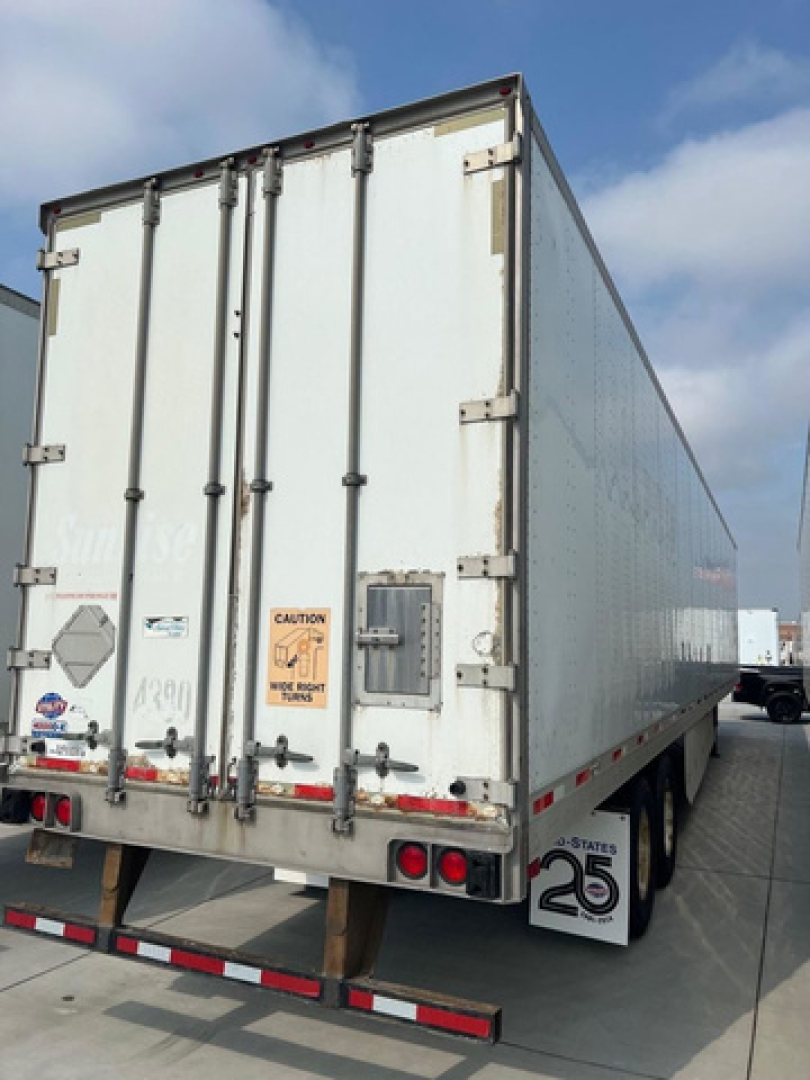Trailer rear view showing double doors, CAUTION sticker, taillights, and undercarriage with a 25 logo on the mudflap.