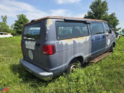 1994 Dodge Ram full-size van side/back view with weathered blue paint, peeling areas, and cargo van body.