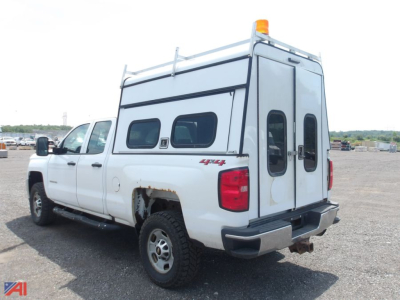 Chevrolet Silverado 2500HD Quad Cab pickup with cap, rear and passenger-side views, white long-bed crew cab, 4x4 badge, utility ladder rack, cab-over cap with dual doors