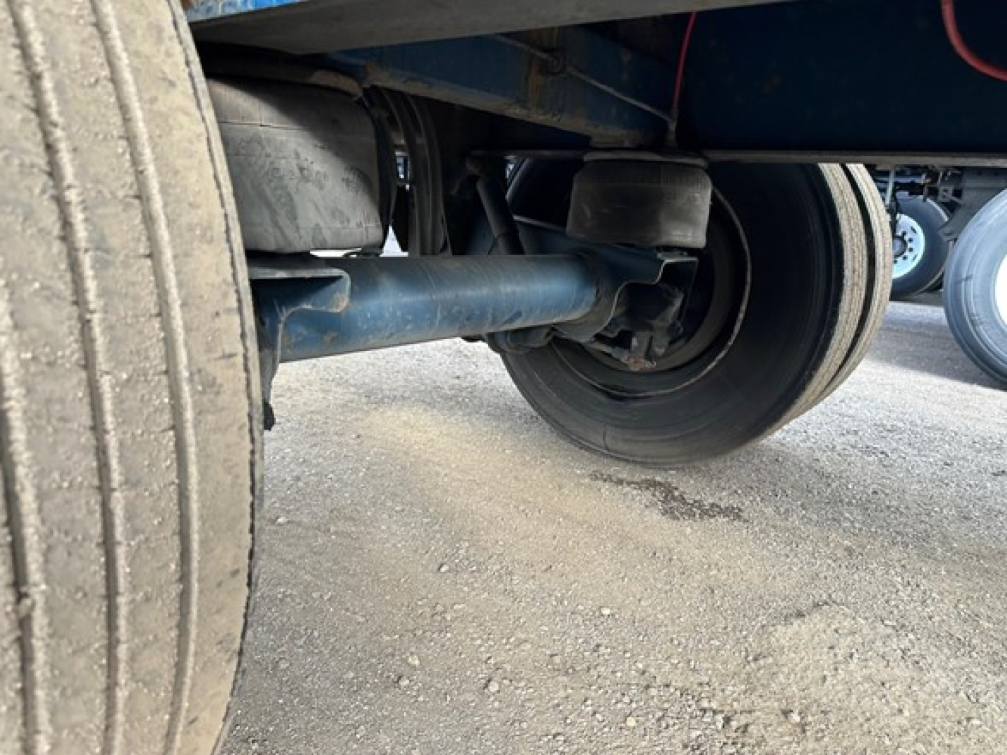 Great Dane Freedom LT trailer undercarriage showing axle, suspension, and dual wheels; no legible model numbers visible.