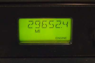 Digital odometer display showing 296,592.4 miles and engine indicator on a Freightliner Cascadia 125 dash panel.