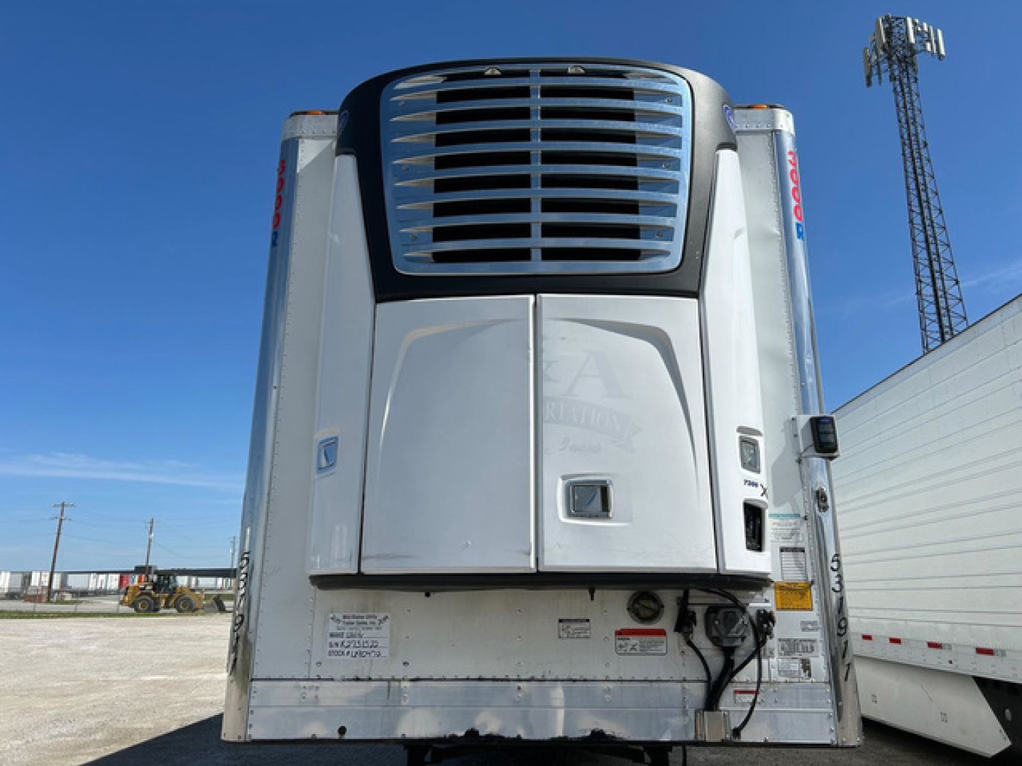 Rear view of a 2019 Utility Reefer trailer with silver body and thermoking unit, showing bumper area and electrical hookups.