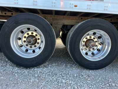 Dual rear axles of a 2019 Utility reefer trailer with silver wheels, black tires, and visible undercarriage and frame.