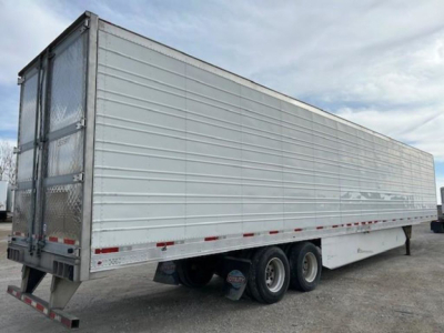 Utility reefer trailer showing side panels and dual rear wheels.