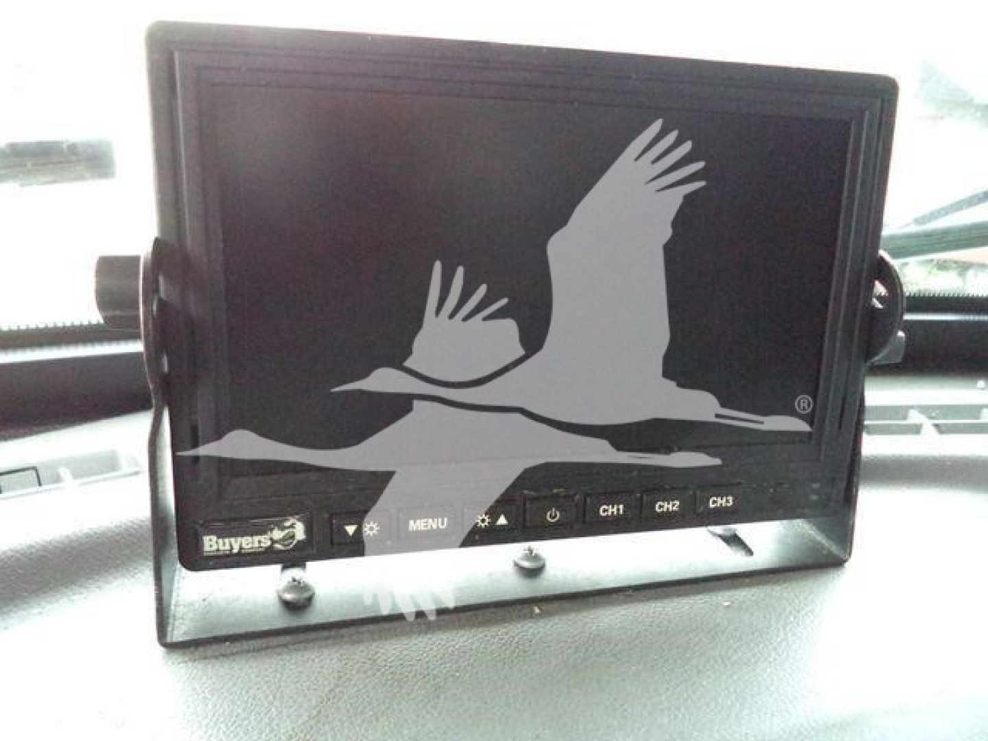 In-dash monitor displaying a Buyer's logo with a seagull graphic; several buttons labeled MENU and CH1 CH2 CH3 along bottom edge.