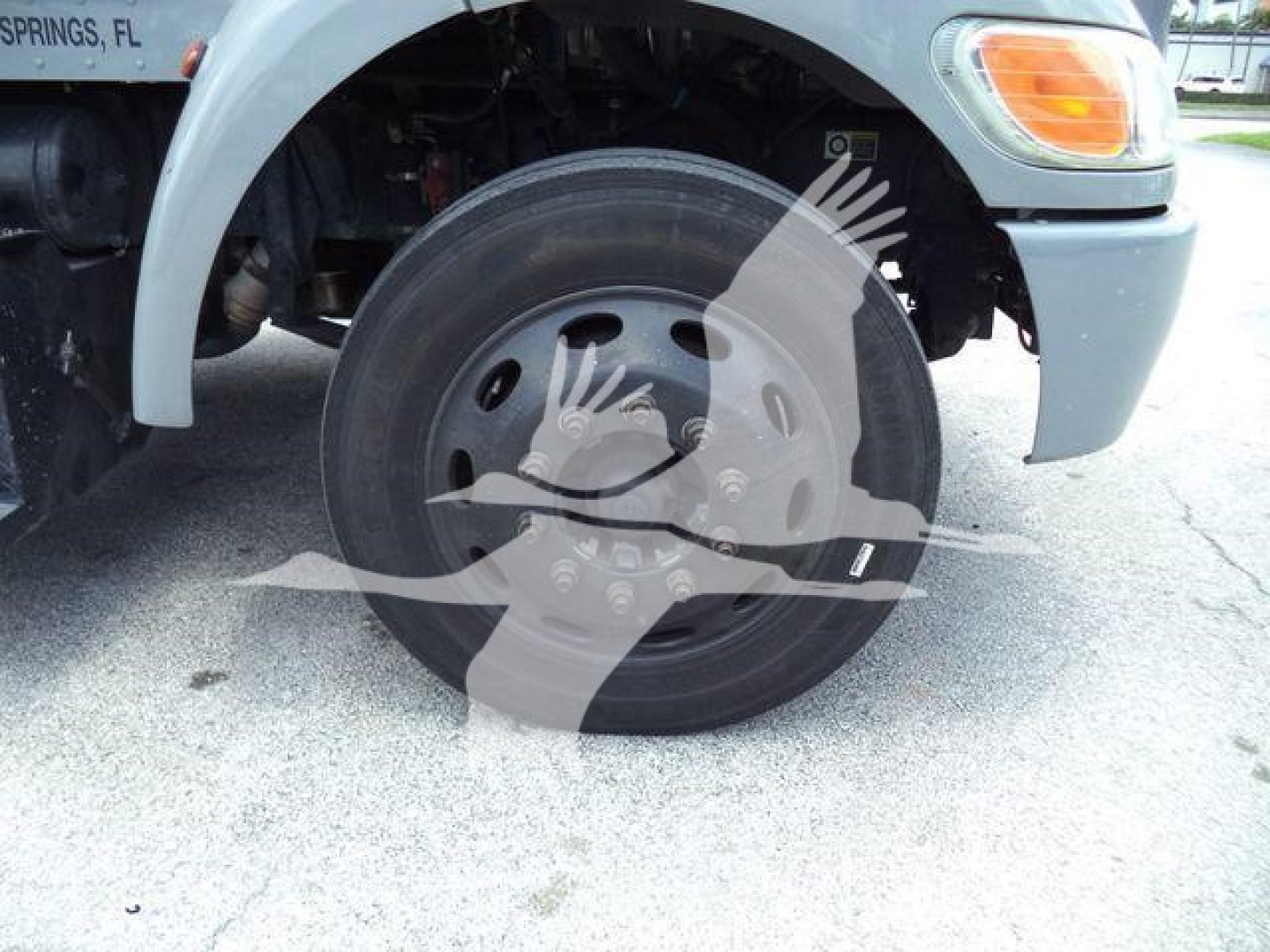 Peterbilt 337 front wheel and fender showing tire and wheel hub, partial cab, storefront watermark overlay.