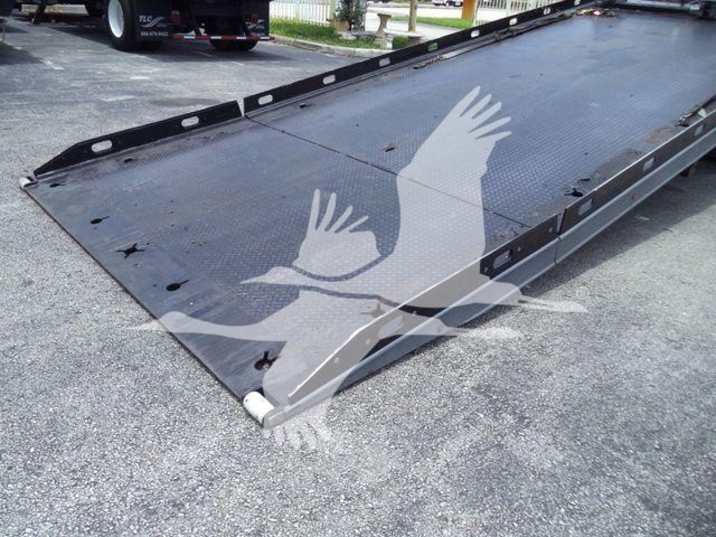 Peterbilt 337 rollback truck bed with lowered steel platform and side rails, viewed from front-right corner.