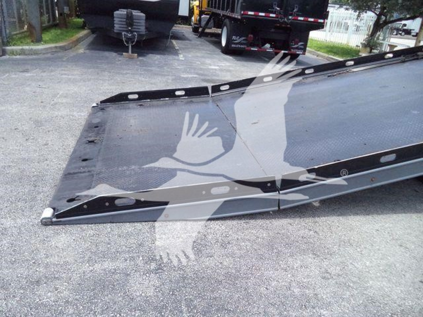 Peterbilt 337 rollback with loading ramp/wedge edge showing metal surface and mounting holes.