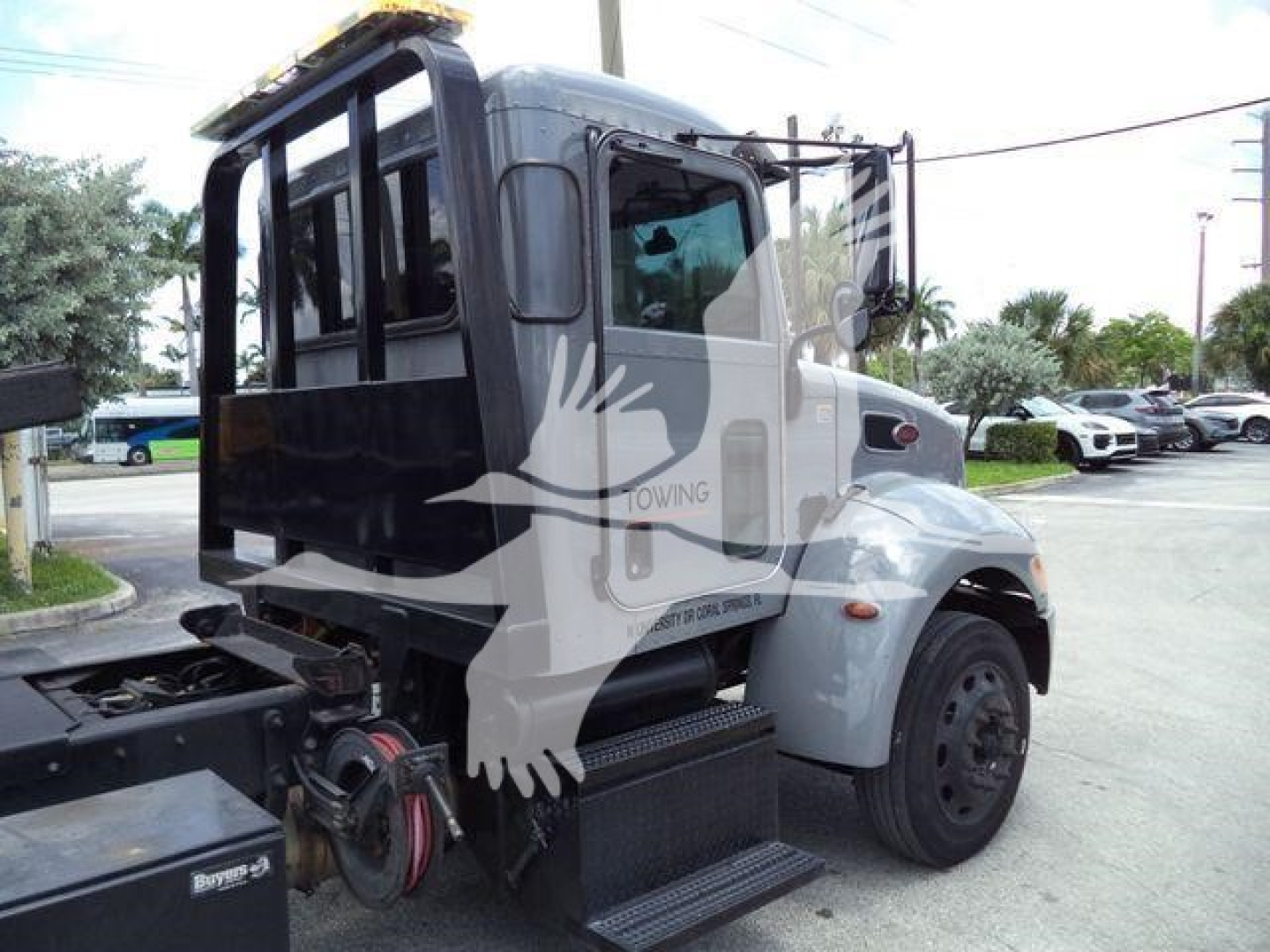 2021 Peterbilt 337 rollback truck side view showing cab doors, steps, and chassis. Visible text includes stock number T59575 and partial VIN 2NP2HM6XXMM759575.
