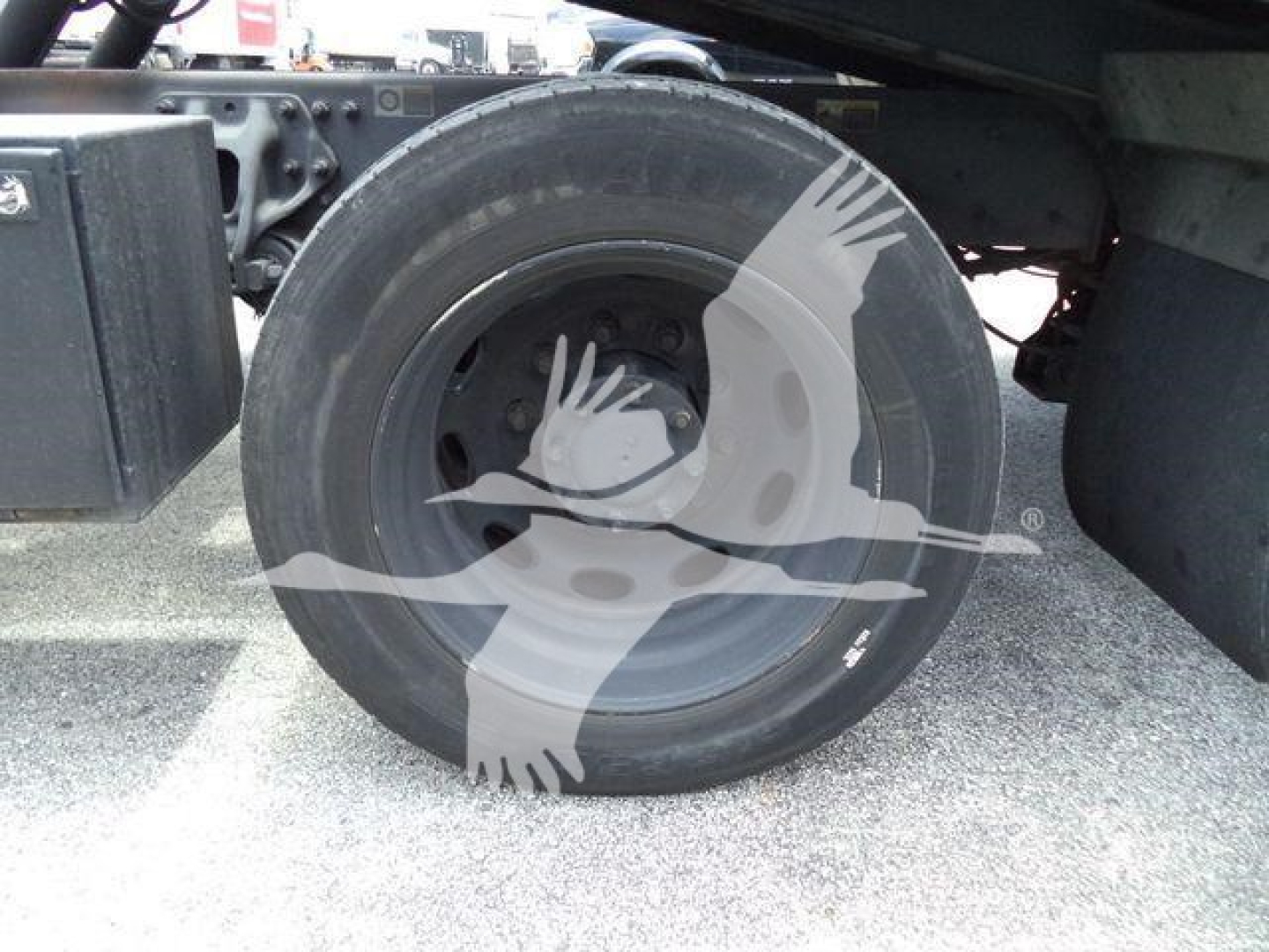 Peterbilt 337 rollback truck wheel and undercarriage showing rear wheel with mudguard and hydraulic components.