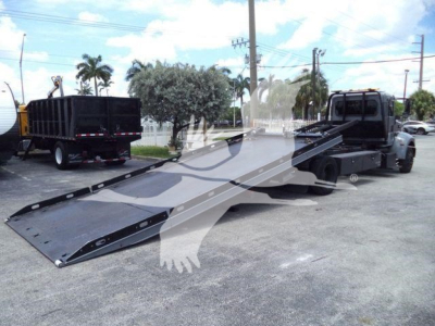 2021 Peterbilt 337 rollback truck with long flatbed/wheel-lift ramps extended, black and gray color, VIN 2NP2HM6XXMM759575 visible on listing, stock number T59575.