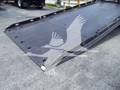 Peterbilt 337 rollback truck bed with lowered steel platform and side rails, viewed from front-right corner.