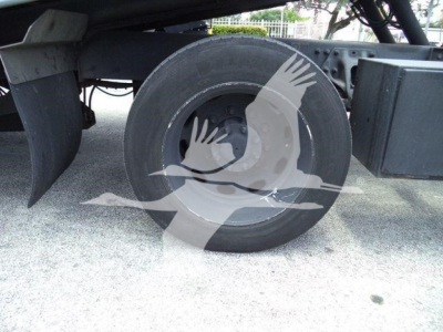 Peterbilt 337 rollback truck undercarriage showing rear wheel and suspension components.