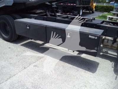 Peterbilt 337 rollback truck side toolbox with storage boxes and frame visible; no legible serials or labels readable beyond small branding on toolbox.