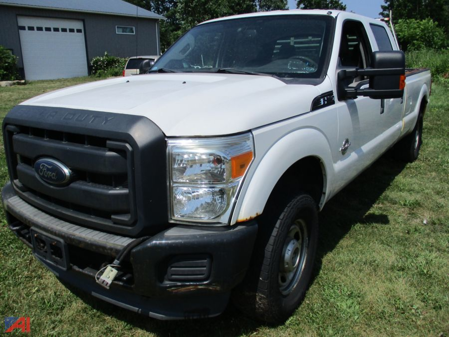 Ford F-250 Super Duty King Ranch Crew Cab pickup truck in white, front-left view, with black grille and bumper, in a grassy lot.