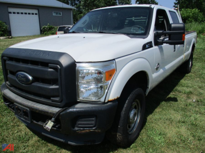 Ford F-250 Super Duty King Ranch Crew Cab pickup truck in white, front-left view, with black grille and bumper, in a grassy lot.