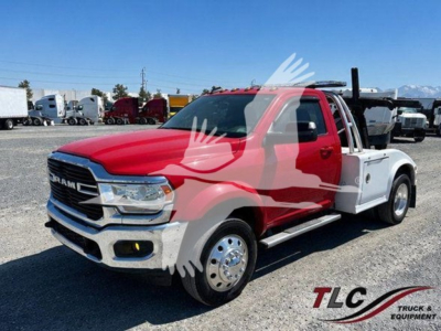 Ram 4500 pickup with red cab and white utility bed, front three-quarter view, showing chrome grille and RAM badge.