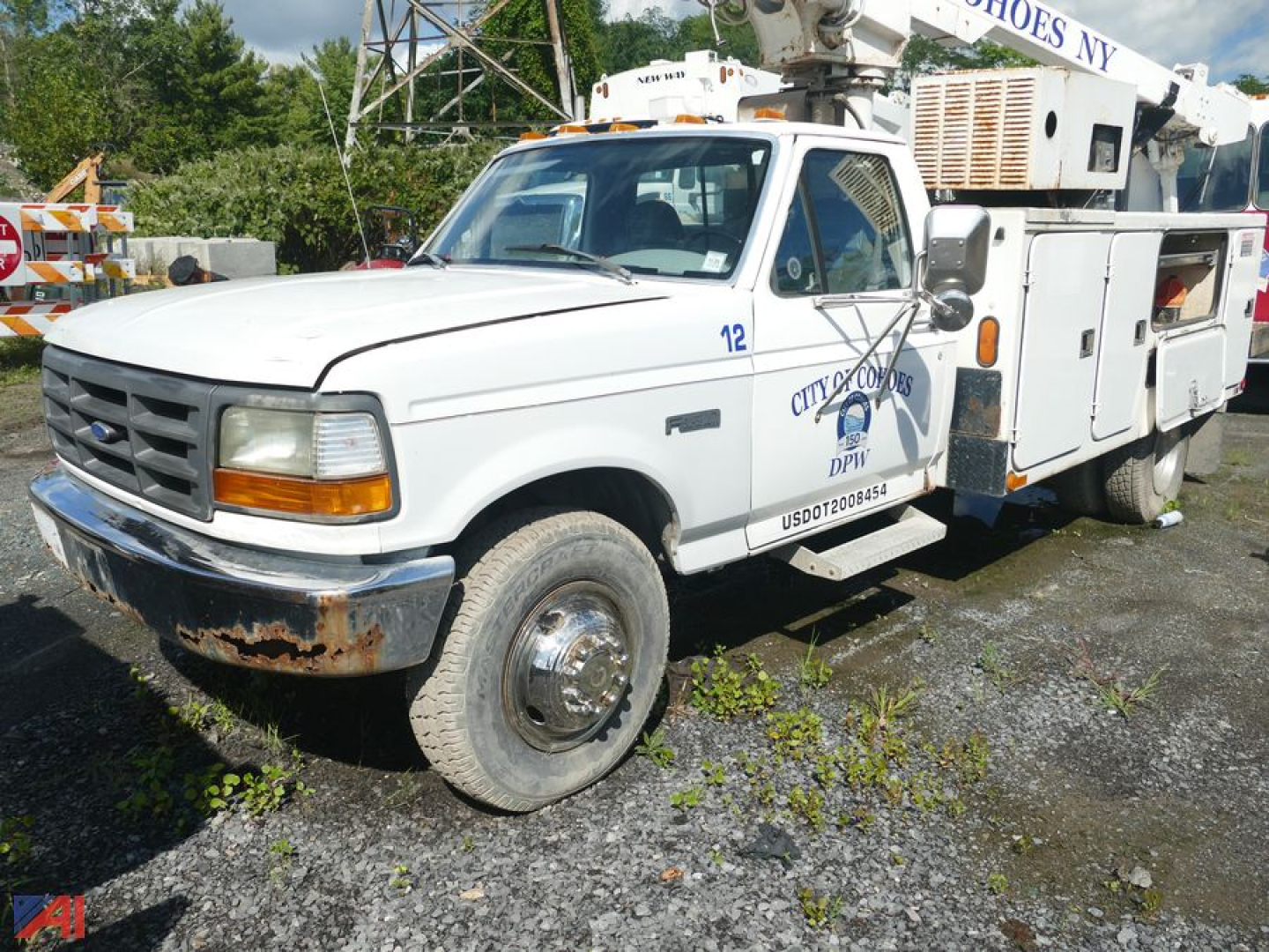 Ford F-Super Duty cab and chassis utility truck showing front grille and service compartments with DPW markings.