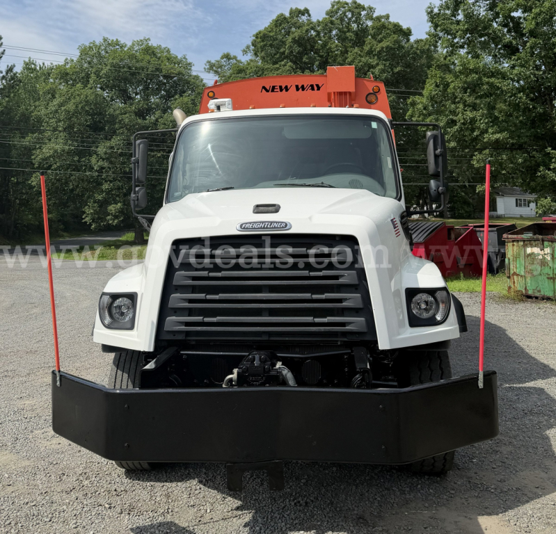 Front view of a white Freightliner 114SD truck with black bumper and orange equipment on top. Visible text includes NEW WAY on top equipment and Freightliner logo on grille.