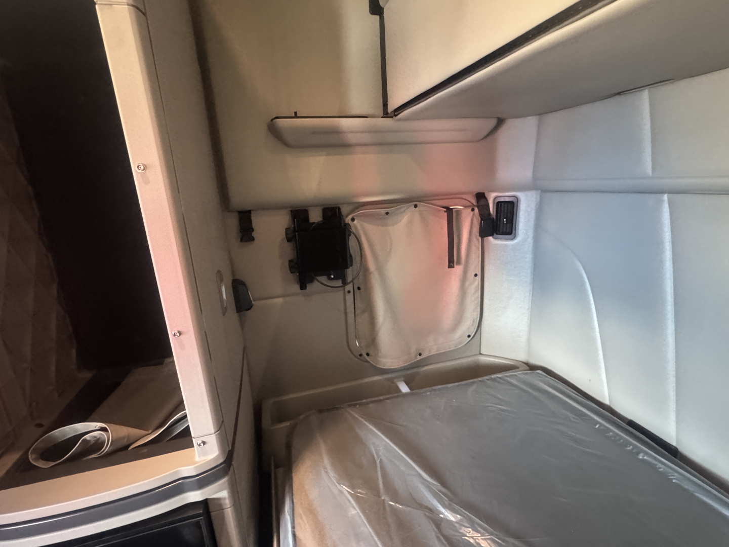 Interior sleeper cab of a Peterbilt 579 with bunk area and control panels visible.