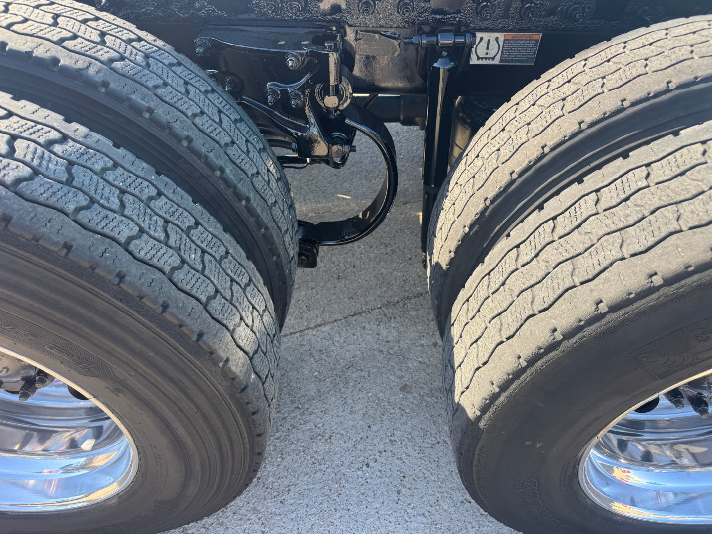 Peterbilt 579 tractor rear dual wheels and suspension undercarriage view showing tires and axle components.