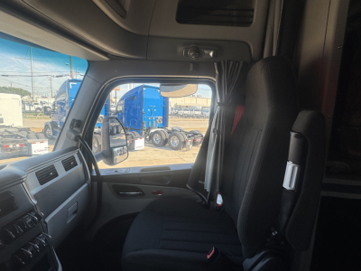 Peterbilt 579 truck interior cabin view from driver seat showing dashboard and window.