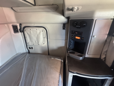 Peterbilt 579 sleeper cab interior with control panel and storage area visible.