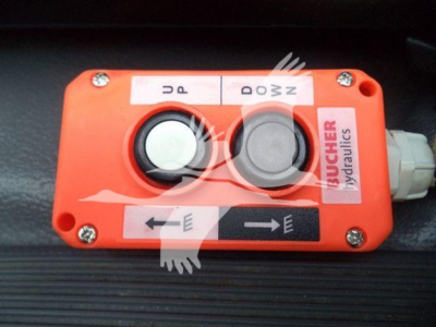 Isuzu truck component showing a hydraulics control box with two round buttons and arrows labeled UP DOWN LEFT RIGHT.