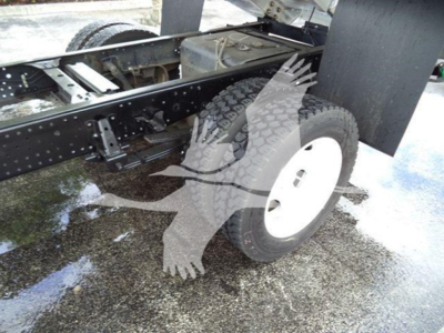 Isuzu NPR XD truck chassis and front wheel area showing frame, suspension, and tire.