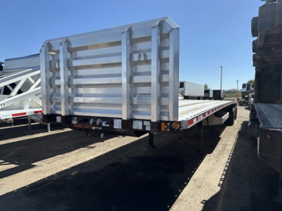 Flatbed trailer with a silver rear ramp/neck gate, 48' Fontaine Infiniity spread air combo looks like standard flatbed with side rails and tail lights.