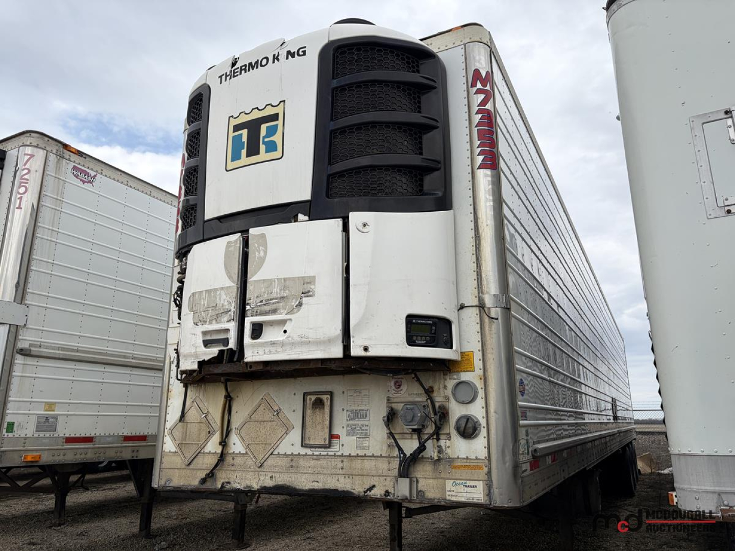 Thermo King unit on front of 53' utility reefer trailer with MZA-? branding, Diamond plate corners, side rails, and refrigeration unit doors. VIN tag and various cables visible.