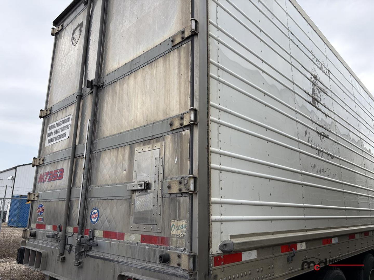 Trailer rear and side of 2017 Utility 53' Tri/A Reefer trailer showing metal doors, hinges, rear bumper, and reflective tape.