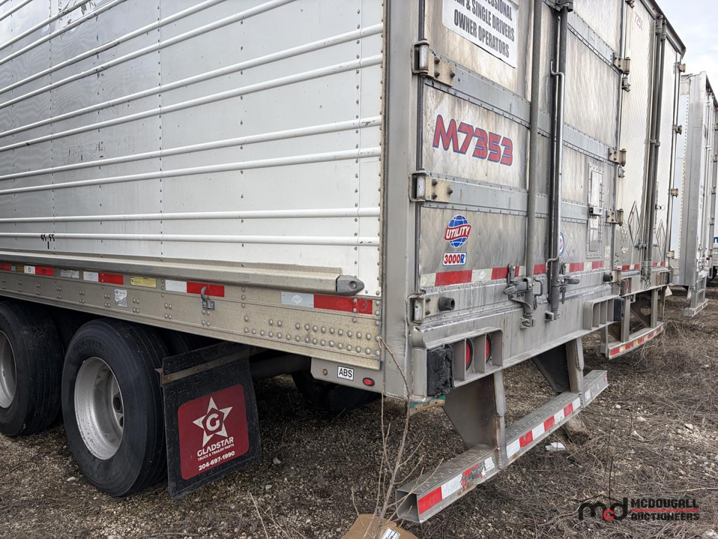 Trailer side view showing 2017 Utility 53' Tri/A Reefer with M353 label, tandem axles, rear doors, and reflective striping.