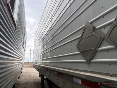 Trailer side view showing stainless steel corrugated wall and rear corner with diamond access hatch, 53' reefer trailer