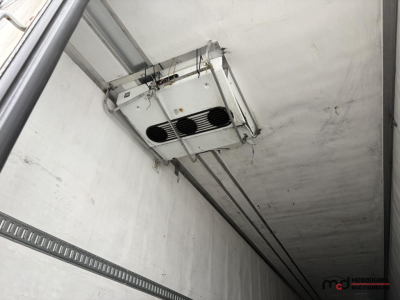 Reefer trailer ceiling unit with hanging refrigeration evaporator in box trailer interior.