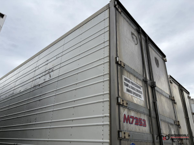 Trailer side and rear doors showing M7355 tag and metal panels on a 53' reefer trailer.