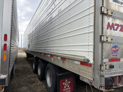 Trailer side view showing 53' tri-axle refrigerated trailer with metal siding, tandem axles, and rear doors; visible logos and VIN plate area.