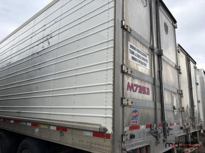 Reefer trailer side and rear showing metal panels, hinges, and M3535 bolt logos with identification numbers on door.