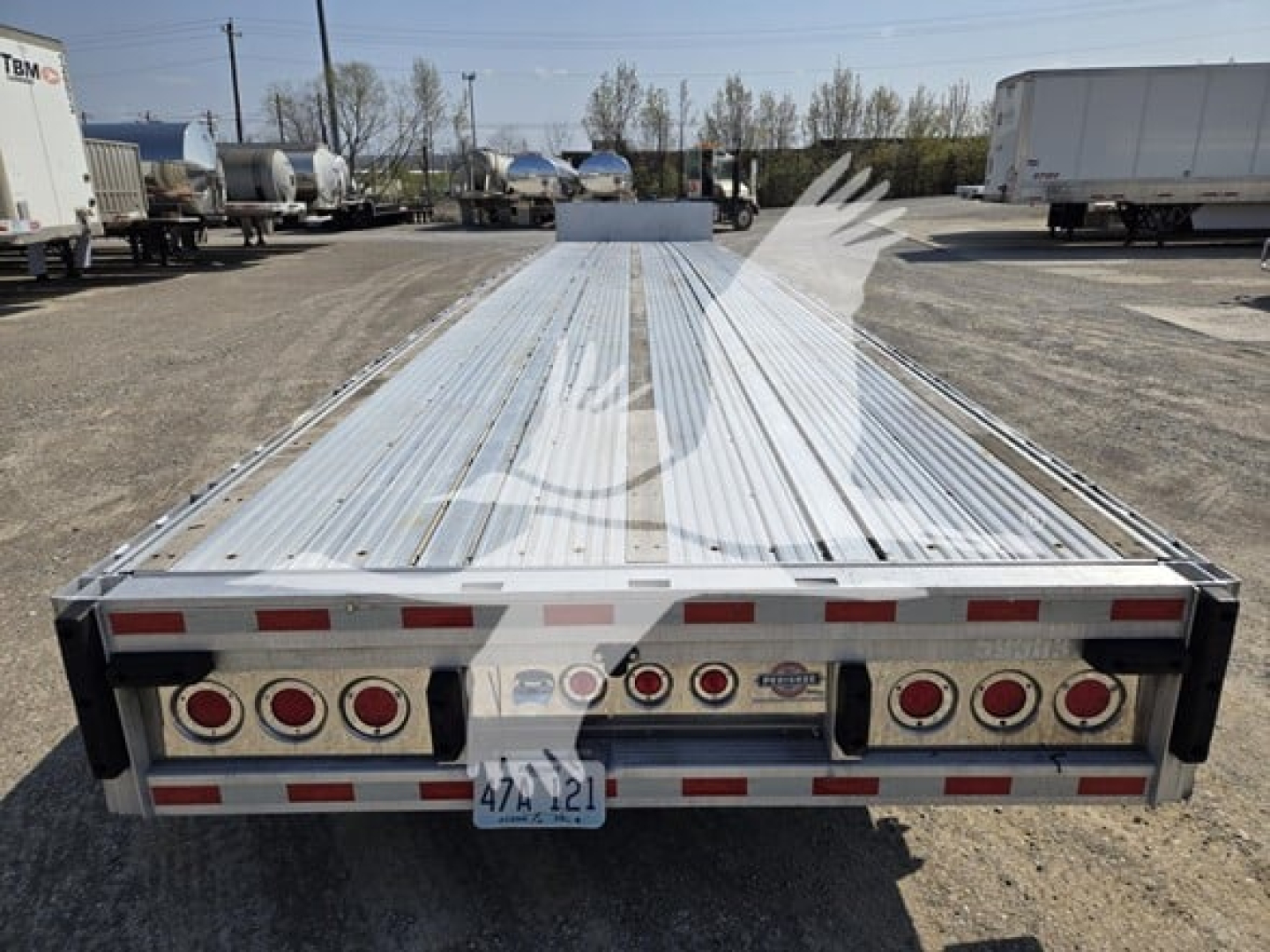 Rear view of a 2019 Reitnouer Dropmiser 53 trailer showing multiple tail lights, bumper, and license plate area.