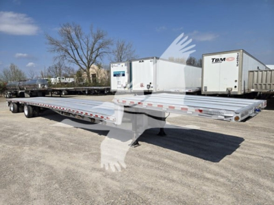 Trailer deck showing a 53-foot drop deck trailer with tandem axles and refrigeration unit in background.