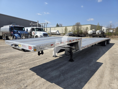 2019 Reitnouer Dropmiser trailer in a used condition showing a long flatbed drop deck with dual axles and landing legs.