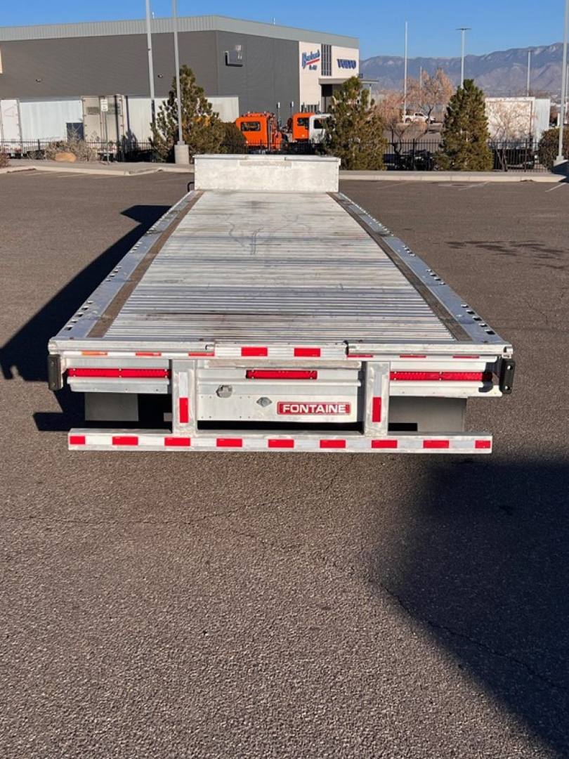 Rear view of a 2020 Fontaine Revolution drop deck trailer showing flatbed surface, rear platform, taillights, and Fontaine branding plate.