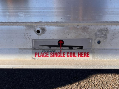  Fontaine Revolution trailer rear showing place single coil here sticker and rear loader area.