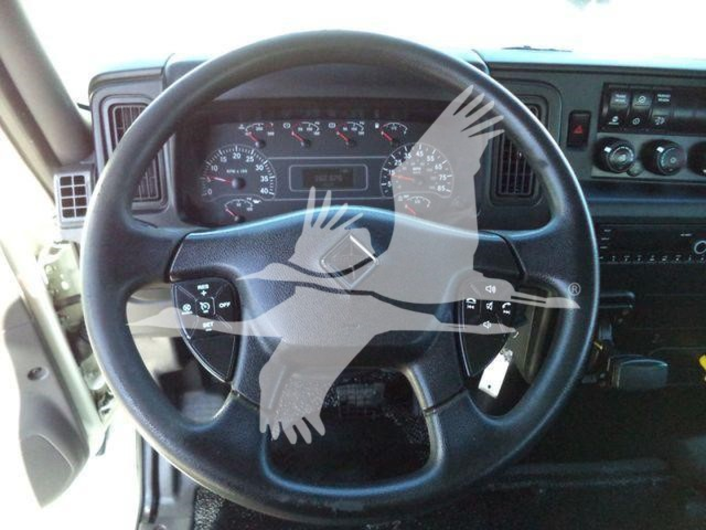 Interior view of a 2021 International MV truck steering wheel and dashboard with gauges and controls visible.