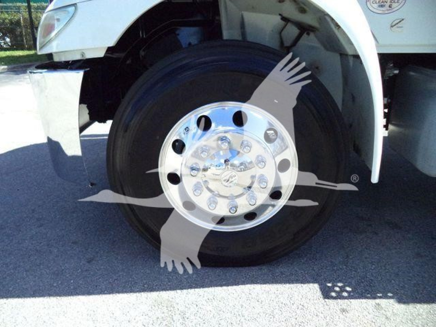 International MV vacuum tank truck wheel and front fender showing large polished aluminum wheel with multiple lug nut holes.