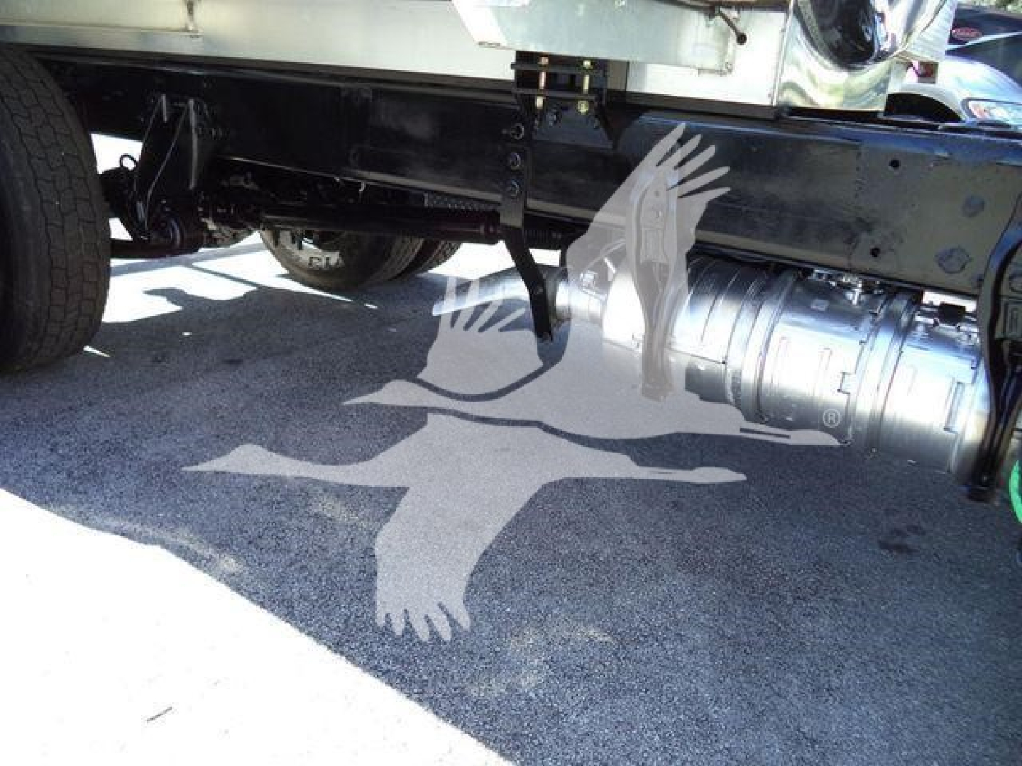 Trucks undercarriage showing vacuum pump and cylindrical tank connection