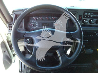 Interior view of a 2021 International MV truck steering wheel and dashboard with gauges and controls visible.