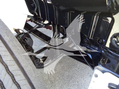International MV vacuum tank truck undercarriage showing engine block and suspension components.