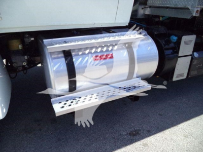 Fuel tank and side step on a 2021 International MV vacuum truck showing chrome cylindrical tank and perforated metal step/step guard.